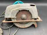 a small circular saw with a blue handle on a table