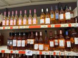 many bottles of wine on the shelves in the store