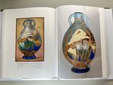two vases on display in a book on a table