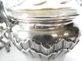 a silver container with a lid on a white table