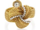 an image of a gold and diamond ring with a watch on it