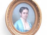 portrait of a woman in a blue dress in a gold frame