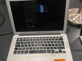 a laptop computer sitting on a desk with a price tag on it