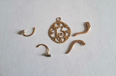 a close up of a gold plated metal object on a white surface