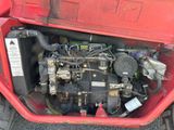 a small engine in the back of a red truck
