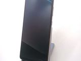 a phone that is sitting on a stand on a table