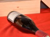 a bottle of wine sitting on a red table cloth