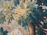an image of a tapestry hanging on a wall next to a tree