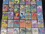 a large collection of pokemon cards sitting on top of a table