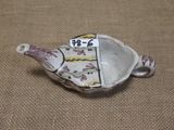 a small ceramic teapot with a price tag on it