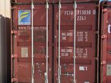 a red shipping container sitting in front of a building