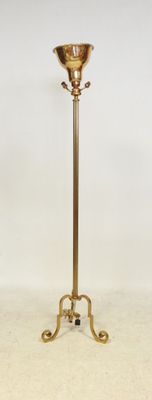 brass plated floor lamp with a glass shade on a stand