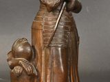 bronze statue of a woman with a child and a dog