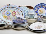 a lot of plates and bowls sitting on a table