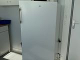 a white refrigerator in a kitchen with a microwave on top of it