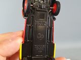 a person holding a small toy car in their hand