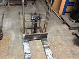a fork lifter sitting in the middle of a warehouse