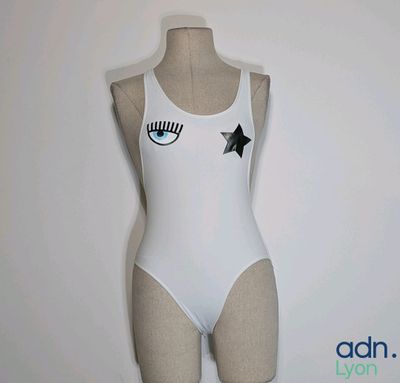 a white bodysuit with a black star on it