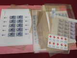 a lot of stamps on a table with a sheet of paper