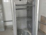 an empty refrigerator in the middle of a room