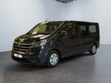 the black van is parked in a large room with a ceiling fan