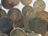 a pile of old coins on a white surface