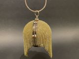 a gold beaded purse with fringes hanging from a chain