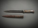 two knives on a table with a black background