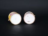 a pair of gold and white porcelain vases with colorful designs