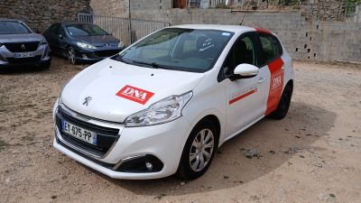 a small white car with a red sticker on the side of it