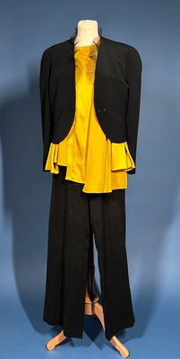 a mannequin wearing a yellow top and black pants