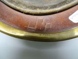 a close up of a metal plate with a tag on it