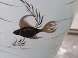 a close up of a vase with a fish painted on it