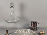 a lot of silver and glass items on the table