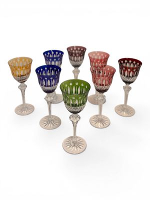 several different colored glass goblets sitting on top of each other