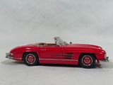 red mercedes 300sl roadster die - cast model car on a white background