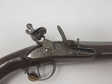 a close up of a gun that is on a white surface