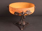 an image of a bowl on a stand with leaves on it
