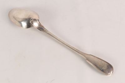 a spoon that is sitting on a white surface