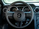 a steering wheel and dashboard of a car in a car