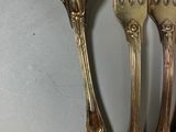 four forks that are sitting next to each other on a table
