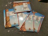 four children ' s books sitting on top of a table next to a pair of scissors