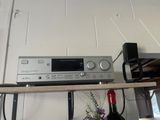 une étagère sur laquelle se trouvent une chaîne hi-fi et une bouteille de vin