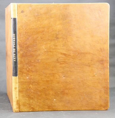 an old book sitting on top of a wooden box on a table