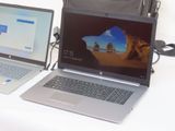 two laptops sitting side by side on a table