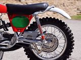 a red dirt bike parked on the side of the road
