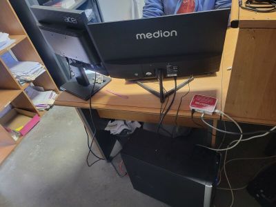 a desk with a computer monitor and a laptop on it