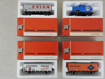 four boxed boxes of toy train cars sitting on top of a table