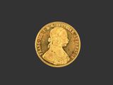 une pièce d'or portant le portrait d'un homme