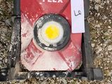 a gas can with an egg in it on the ground